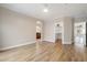 Open-concept living room with hardwood floors, neutral paint, and arched entryway at 10757 N 74Th St # 2003, Scottsdale, AZ 85260