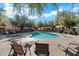 Community pool area featuring a large pool, lounge chairs, and shaded seating areas for relaxing by the water at 10757 N 74Th St # 2003, Scottsdale, AZ 85260