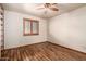 Neutral-colored bedroom features a ceiling fan and a shuttered window at 109 W Kathleen Rd, Phoenix, AZ 85023