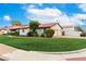 Well-manicured lawn, red tile roof, arched windows, and a charming garage at 109 W Kathleen Rd, Phoenix, AZ 85023