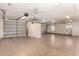 Spacious garage with painted floors, cabinets, and multiple ceiling fans at 109 W Kathleen Rd, Phoenix, AZ 85023