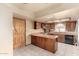 Functional kitchen with wood cabinets, tiled floors, and a breakfast bar, blending style with practicality at 109 W Kathleen Rd, Phoenix, AZ 85023