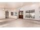 Bright living room with tile flooring, large windows, and a unique arched entryway creating an airy ambiance at 109 W Kathleen Rd, Phoenix, AZ 85023