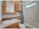 Bright bathroom featuring a vanity with wood cabinets, a white sink, and a shower-tub combination at 111 S Greenfield Rd # 660, Mesa, AZ 85206