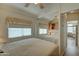 Inviting bedroom featuring a full-size bed, mirrored closet doors, and laminate flooring that extends throughout at 111 S Greenfield Rd # 660, Mesa, AZ 85206