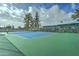 Well-maintained tennis court surrounded by fencing and greenery at 111 S Greenfield Rd # 660, Mesa, AZ 85206