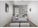 Inviting bedroom with stylish grey bedding, stone-look accent wall, and modern design elements at 1130 N 2Nd St # 411, Phoenix, AZ 85004