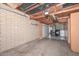 Unfinished basement area with exposed brick and utility access at 11388 N 114Th Dr, Youngtown, AZ 85363