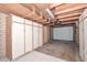 Unfinished basement with exposed ceiling, white cabinets, and access to the garage at 11388 N 114Th Dr, Youngtown, AZ 85363