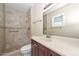 Renovated bathroom featuring a walk-in shower, modern vanity, updated fixtures, and tile flooring at 11388 N 114Th Dr, Youngtown, AZ 85363