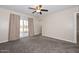 Bedroom with a fan and sliding glass door to outside at 11388 N 114Th Dr, Youngtown, AZ 85363