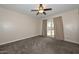 Bedroom with a fan and sliding glass door to outside at 11388 N 114Th Dr, Youngtown, AZ 85363