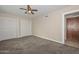 Spacious bedroom featuring neutral walls, ceiling fan and carpet at 11388 N 114Th Dr, Youngtown, AZ 85363