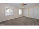 Bright bedroom with carpet, a ceiling fan and window with blinds at 11388 N 114Th Dr, Youngtown, AZ 85363