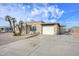 Lovely single-story home featuring mature palm trees, a spacious driveway, and an attached two-car garage at 11388 N 114Th Dr, Youngtown, AZ 85363