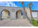 Charming single-story home with arched entryway, desert landscaping, and a private courtyard at 11388 N 114Th Dr, Youngtown, AZ 85363