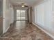 Open hallway offering access to the backyard via glass sliding doors at 11388 N 114Th Dr, Youngtown, AZ 85363