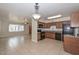 Open kitchen with dark cabinetry and appliances, tile floors, and an open layout at 11388 N 114Th Dr, Youngtown, AZ 85363