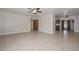 Spacious living room featuring tile flooring, ceiling fan, and a large window that provides natural light at 11388 N 114Th Dr, Youngtown, AZ 85363