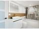 Well-lit bathroom features modern fixtures, sleek white vanity, and a stand-alone tub with marble accent wall at 11601 N 64Th Pl, Scottsdale, AZ 85254