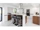 Sleek modern kitchen with waterfall island, stainless steel appliances, and a stylish backsplash at 11601 N 64Th Pl, Scottsdale, AZ 85254