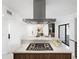 Spacious open kitchen featuring a modern island, stainless steel range hood, and elegant countertops at 11601 N 64Th Pl, Scottsdale, AZ 85254