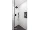 Modern shower with black fixtures, geometric tile floor, and a built-in shelf at 11601 N 64Th Pl, Scottsdale, AZ 85254