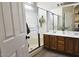 Bathroom featuring double sinks, wooden cabinets, and glass enclosed walk-in shower at 12360 W Sherman St, Avondale, AZ 85323