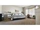 Bright bedroom with a modern iron bed frame, light gray walls, and lots of natural light at 12360 W Sherman St, Avondale, AZ 85323