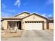 Charming single-story home featuring a well-maintained lawn, neutral-toned exterior, and a two-car garage at 12360 W Sherman St, Avondale, AZ 85323