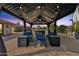 Cozy gazebo featuring comfortable seating, a fan, and a fire pit for relaxation at 12806 W Jadestone Dr, Sun City West, AZ 85375