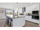 Bright kitchen featuring white cabinetry, stainless steel appliances, a granite island and pendant lighting at 12806 W Jadestone Dr, Sun City West, AZ 85375