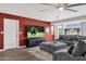 Relaxing living room featuring a contemporary sofa and a large television for entertainment at 12806 W Jadestone Dr, Sun City West, AZ 85375