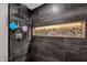 Close up of modern shower with rainfall shower head and lighted rock display at 12806 W Jadestone Dr, Sun City West, AZ 85375