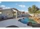 The backyard features a private pool, desert landscaping and a covered patio at 13326 W Watson Ln, Surprise, AZ 85379