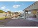 Inviting backyard featuring a refreshing pool, charming rock features, and a covered patio at 13326 W Watson Ln, Surprise, AZ 85379