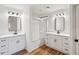 Bathroom featuring dual sinks, granite countertops, modern lighting and tub with shower at 13326 W Watson Ln, Surprise, AZ 85379