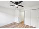 Bedroom features wood floors, a ceiling fan and closet with sliding doors at 13326 W Watson Ln, Surprise, AZ 85379