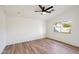 Bright bedroom with wood floors, ceiling fan and a window with natural light at 13326 W Watson Ln, Surprise, AZ 85379