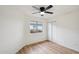 Bedroom with wood-look floors, ceiling fan, window and a closet with sliding doors at 13326 W Watson Ln, Surprise, AZ 85379