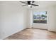 Bedroom showcasing wood floors, ceiling fan and a window with a neighborhood view at 13326 W Watson Ln, Surprise, AZ 85379