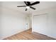 Bright bedroom features a ceiling fan, wood floors, and a closet with sliding doors at 13326 W Watson Ln, Surprise, AZ 85379