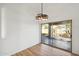 The dining room features wood-look flooring, new lighting and sliding glass door to the backyard at 13326 W Watson Ln, Surprise, AZ 85379