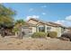 Charming home featuring a well-maintained lawn, mature trees, and a two-car garage at 13326 W Watson Ln, Surprise, AZ 85379