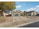 Attractive home exterior with a spacious driveway, a two-car garage, and manicured landscaping at 13326 W Watson Ln, Surprise, AZ 85379