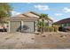 Charming single-story home featuring a three-car garage, desert landscaping, and mature palm trees at 13326 W Watson Ln, Surprise, AZ 85379