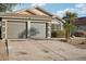 A spacious two-car garage with an extended driveway, and manicured landscaping at 13326 W Watson Ln, Surprise, AZ 85379