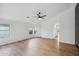 Bright living room with ample natural light, ceiling fan, and light wood-style flooring at 13326 W Watson Ln, Surprise, AZ 85379