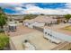 Aerial view of a home with a spacious driveway with trailer parking and a detached garage with a gravel side yard at 1349 E Anasazi St, Mesa, AZ 85203