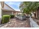 Hot tub is nestled in a backyard retreat with covered patio, bordered by manicured landscaping and a stone border at 1349 E Anasazi St, Mesa, AZ 85203